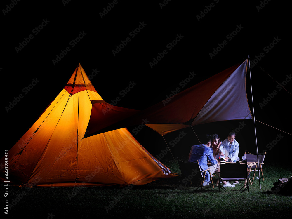 A Happy family of three camping outdoors