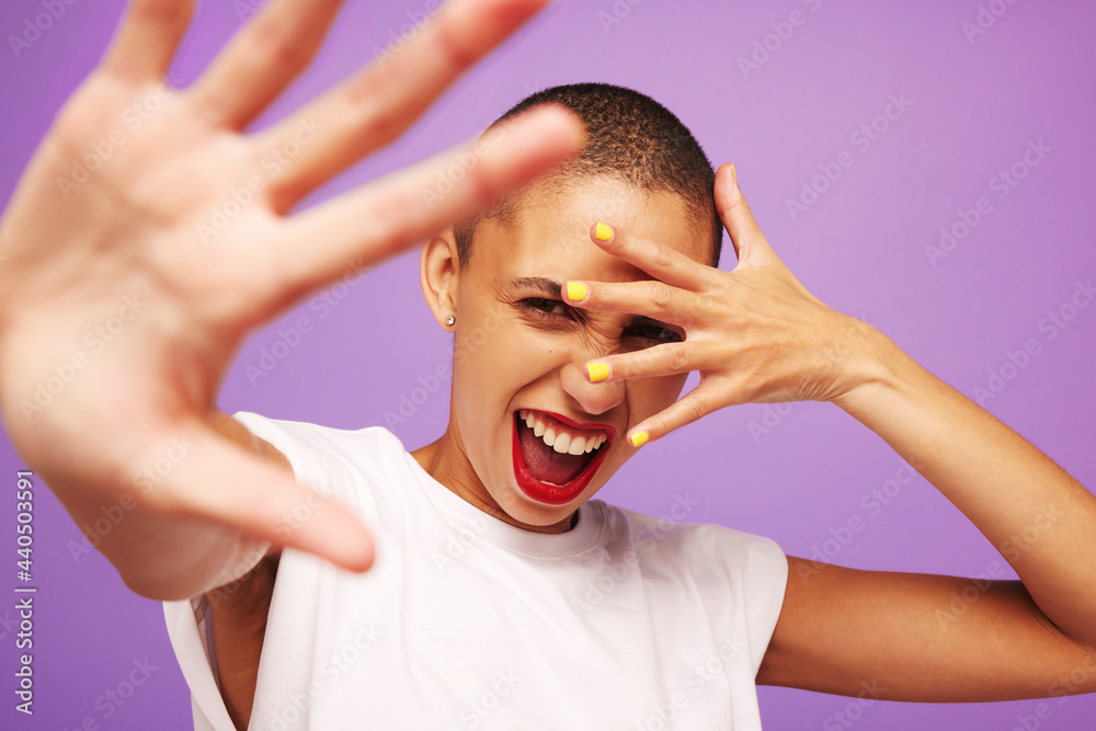Excited female model on purple background
