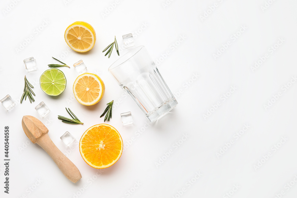 Composition with glass and healthy citrus fruits on white background