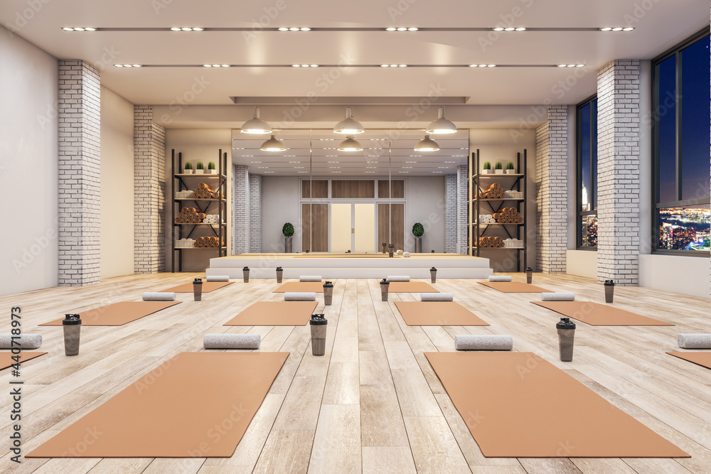 现代混凝土瑜伽馆内部配有设备、夜城景观和木地板。健康生活