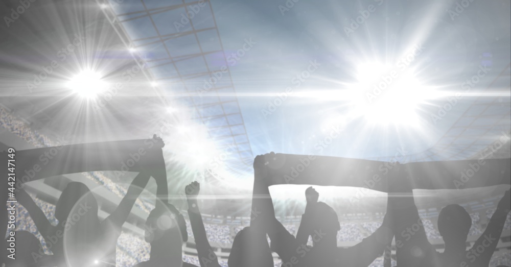体育场里戴围巾的体育迷的构成，有发光的聚光灯和复制空间