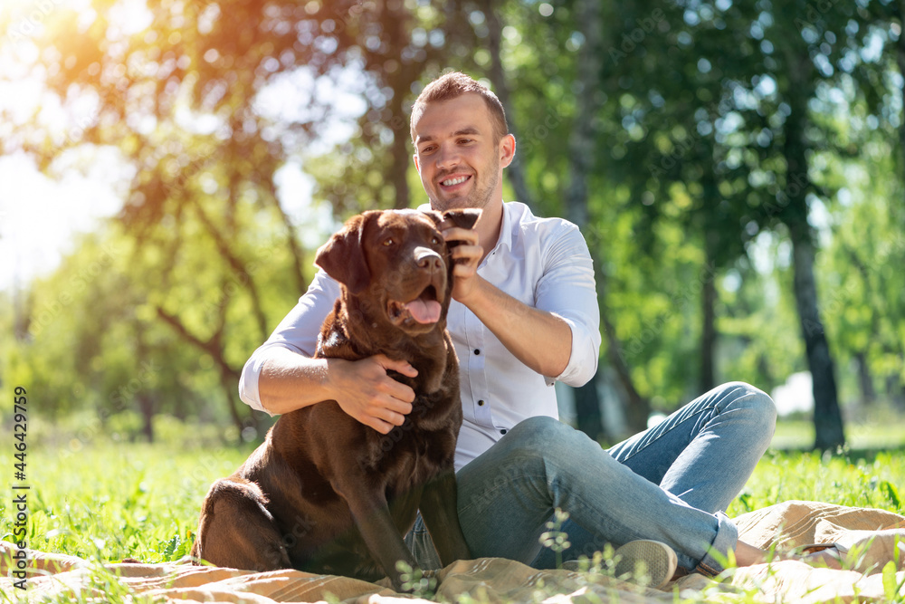 Young man with a dog in the park