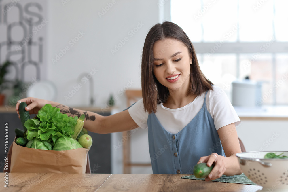 厨房里有新鲜蔬菜的年轻女人