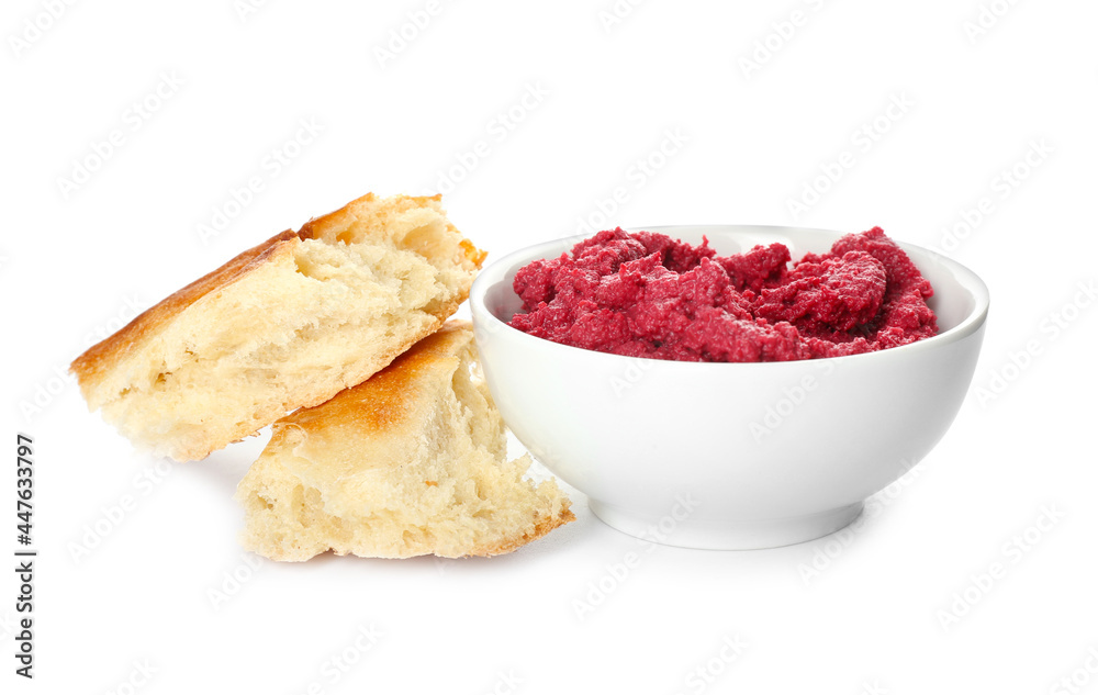 Bowl with tasty beet hummus and pita bread on white background