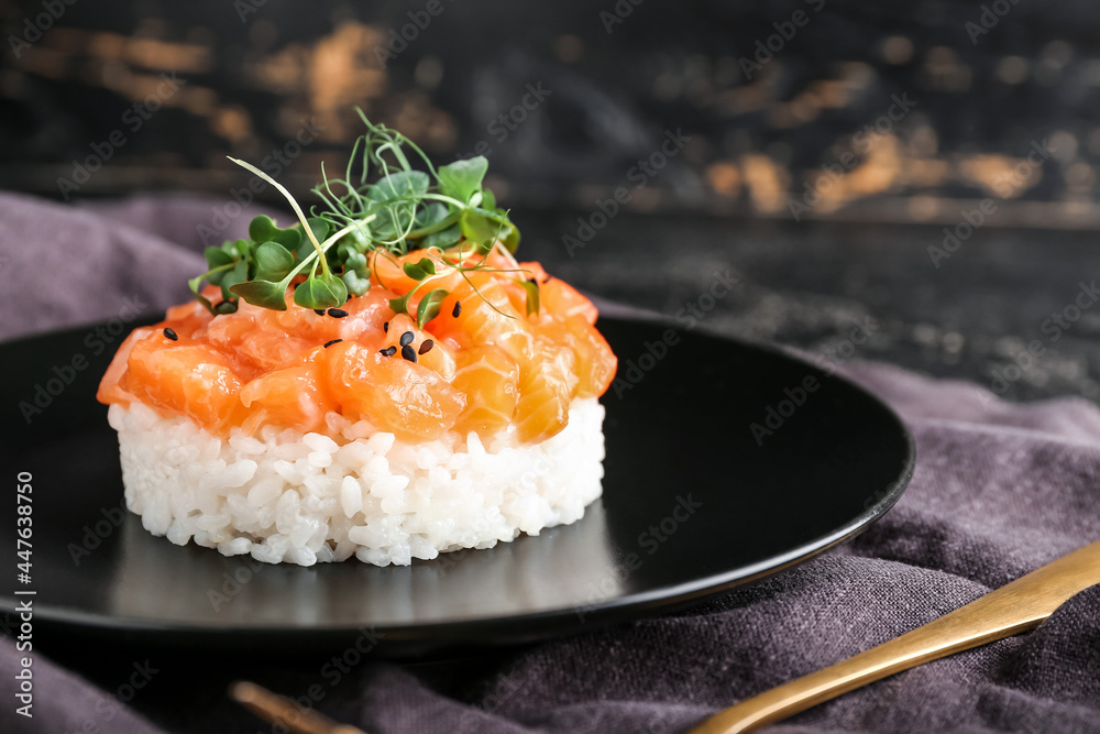 Delicious salmon tartar on dark background, closeup