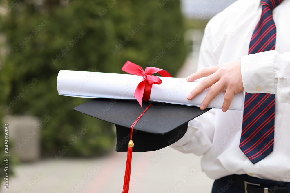 Male graduating student outdoors, closeup