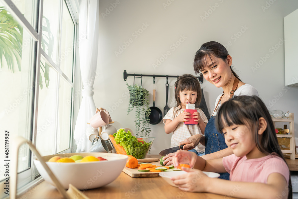 Asian happy family, mother spend time with young daughter in kitchen
