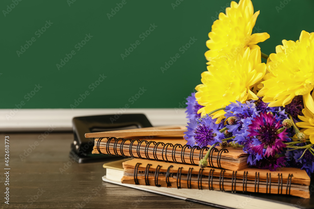 教室桌子上摆放着美丽的鲜花和文具。教师节庆祝活动