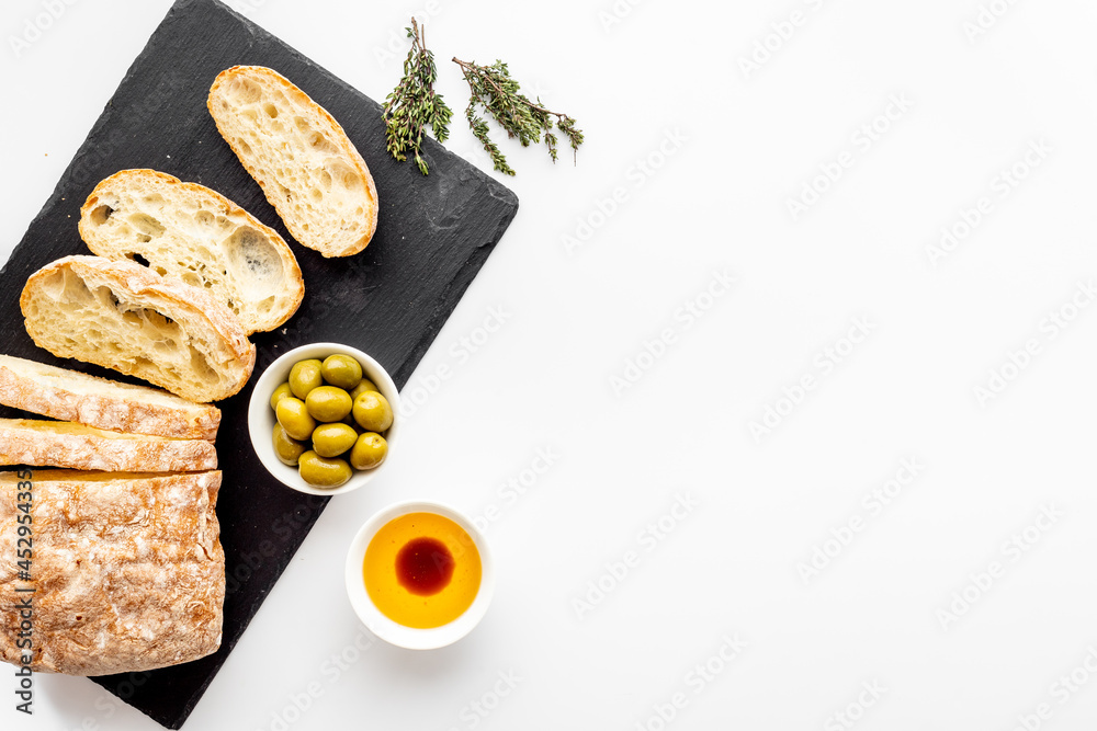 Olive oil on slice of bread with olives. Italian food appetizer