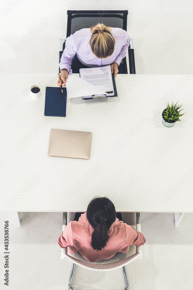 Two young business women in meeting at office table for job application and business agreement. Recr
