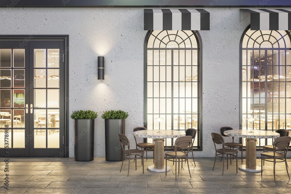 Modern concrete cafe exterior with terrace furniture at night. 3D Rendering.