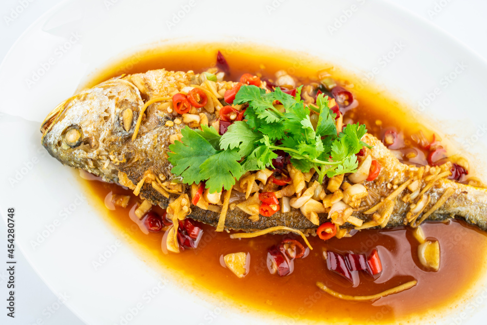 A braised yellow croaker on white background
