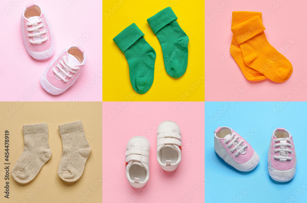 Stylish baby socks and shoes on color background