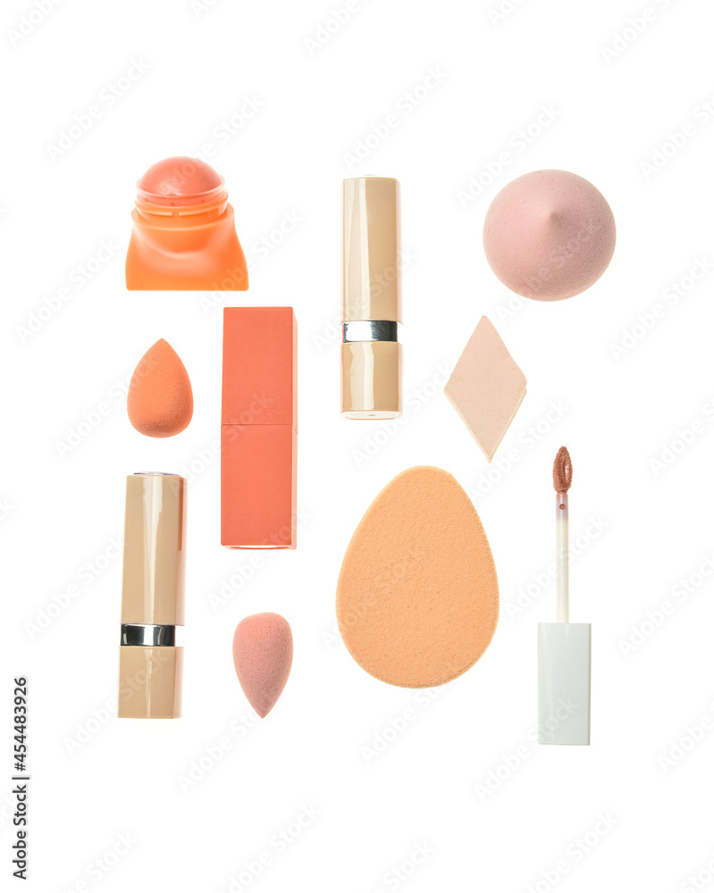 Set of makeup cosmetics and sponges on white background