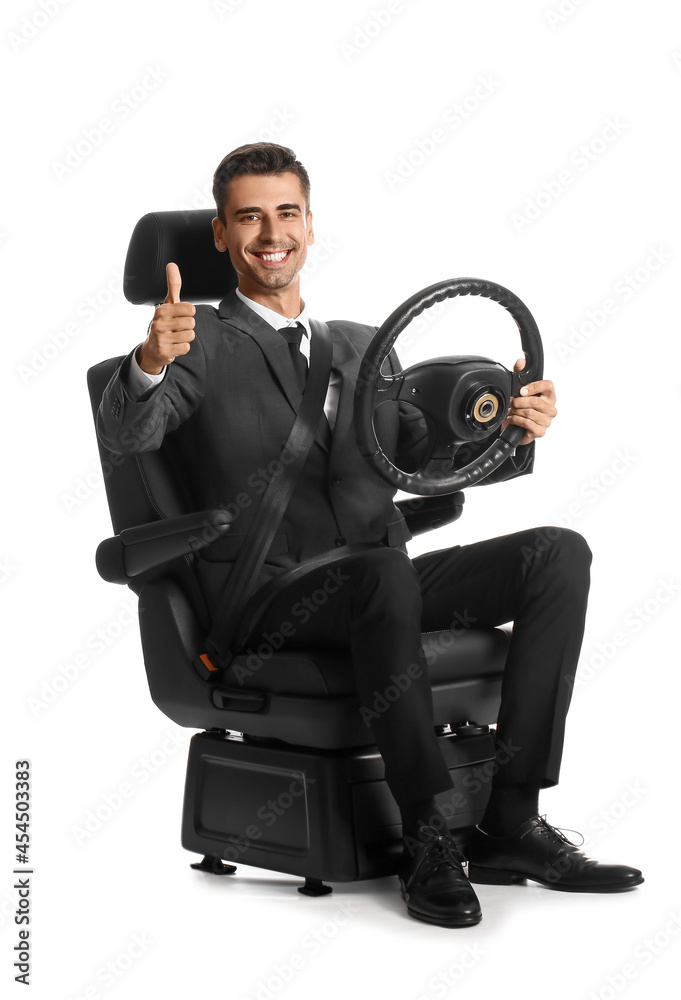 Businessman in car seat and with steering wheel showing thumb-up on white background
