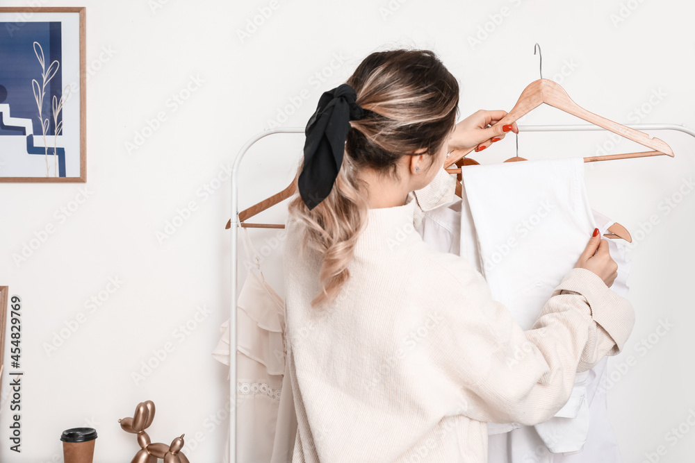 Female stylish with clothes in studio