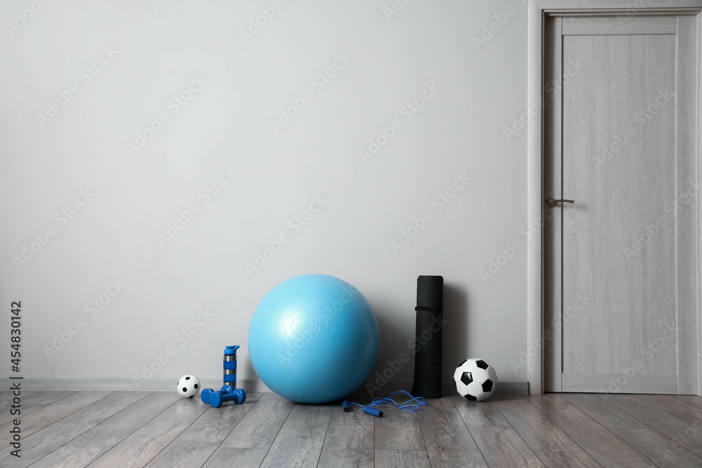 Set of sports equipment on floor in gym