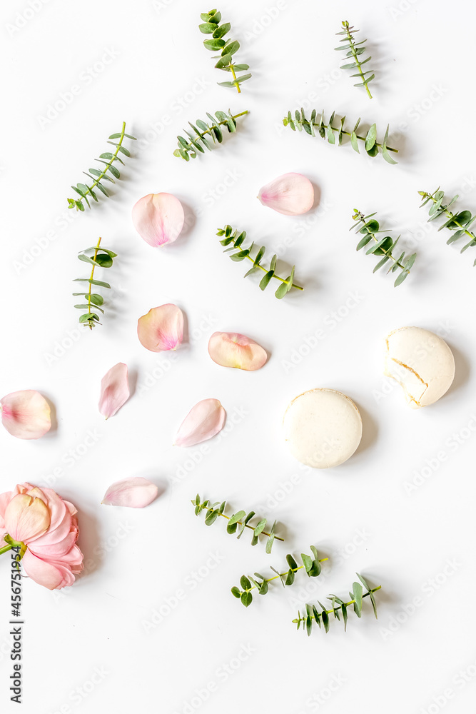 woman table design with flower and macaroons in soft light top view