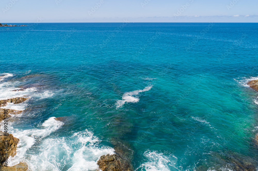 Aerial view Top down seashore wave crashing on seashore Beautiful turquoise sea surface in sunny day
