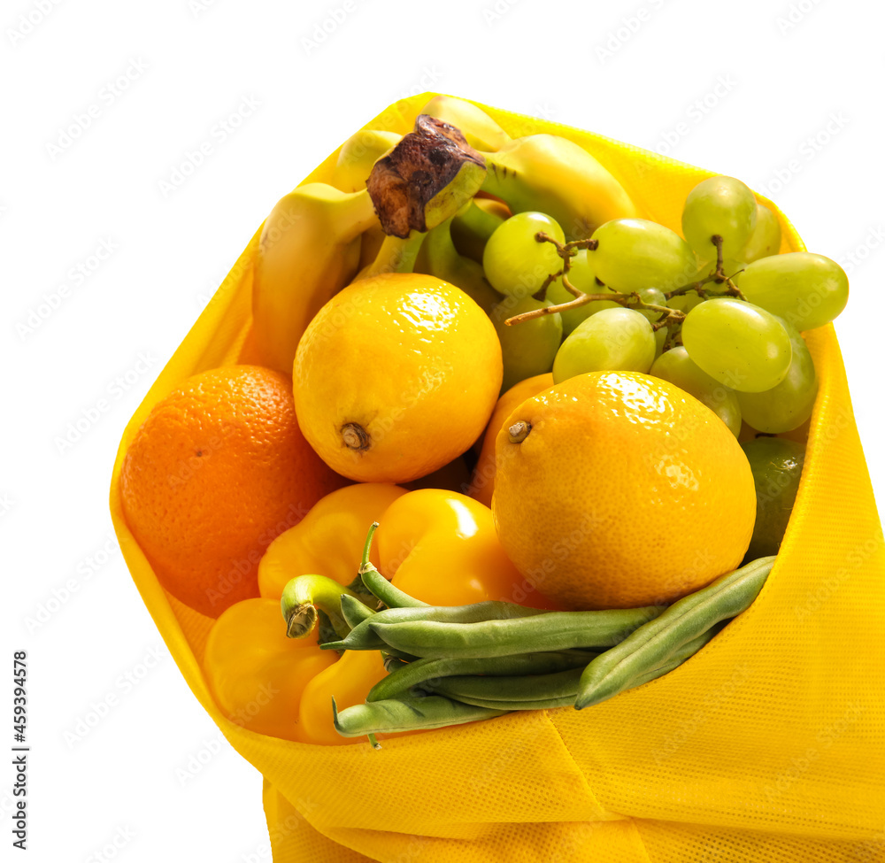 Eco bag with fruits and vegetables on white background, closeup