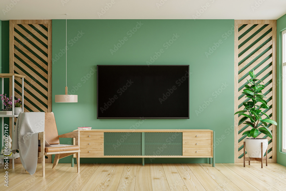 绿色墙壁背景，带电视柜的现代客厅装饰。