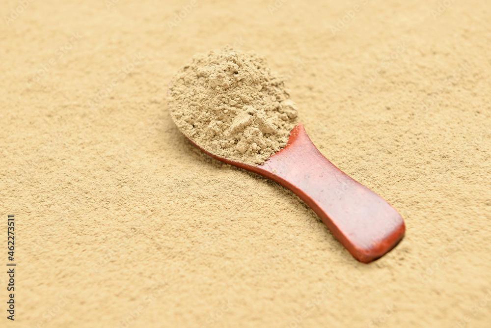 Natural hojicha powder with spoon as background