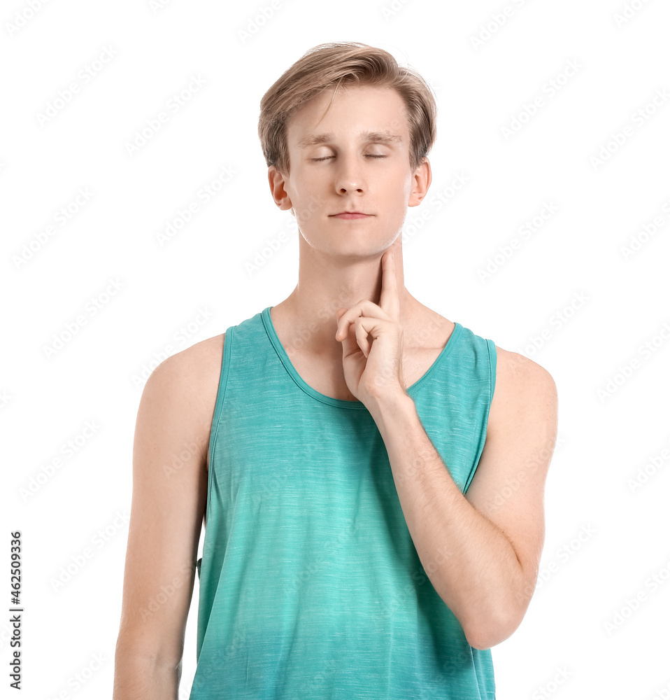 Sporty young man counting pulse on white background