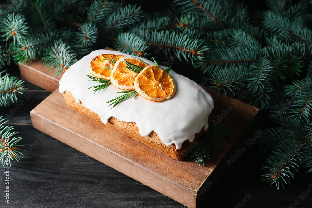 Board with tasty Christmas stollen on table