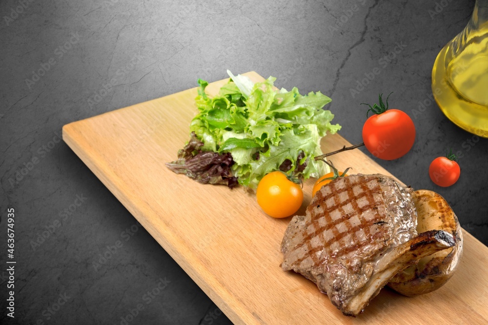 grilled meat steak with spices on a wooden board