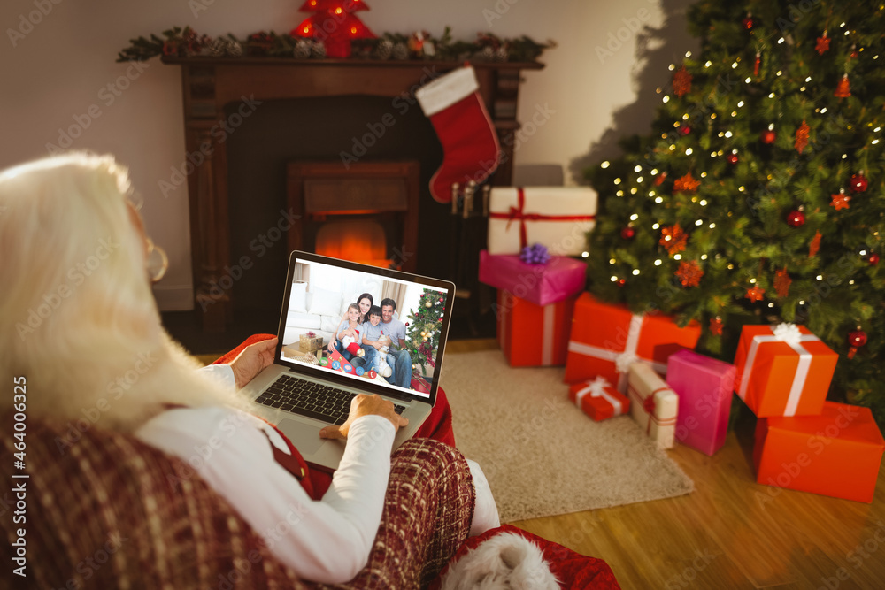 高加索老年妇女在笔记本电脑上与家人圣诞视频通话