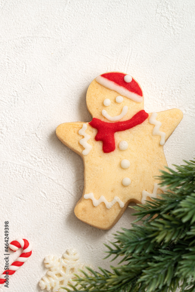 Decorated Christmas gingerbread cookies with decorations on white table background.