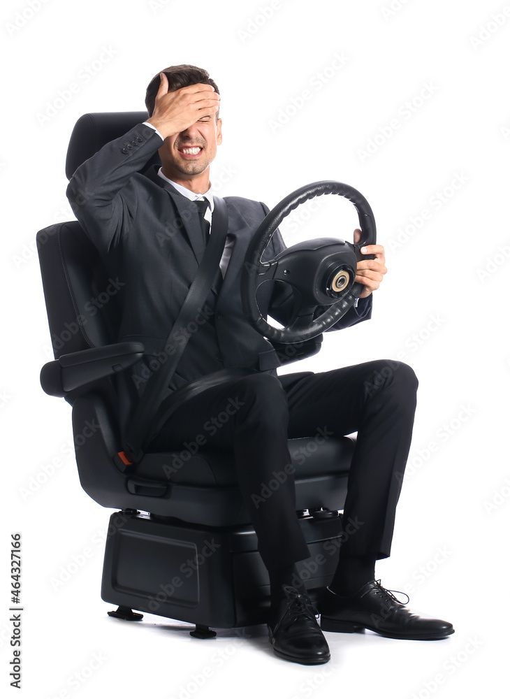 Stressed businessman in car seat and with steering wheel on white background