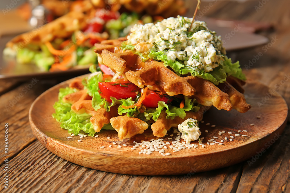 Delicious Belgian waffles with vegetables in plate on wooden background, closeup