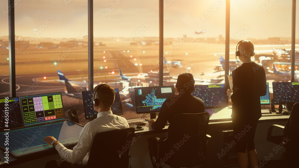 Diverse Air Traffic Control Team Working in a Modern Airport Tower at Sunset. Office Room is Full of