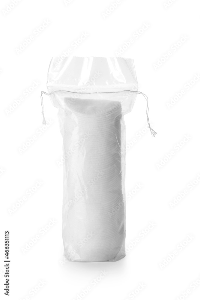 Packed cotton pads on white background