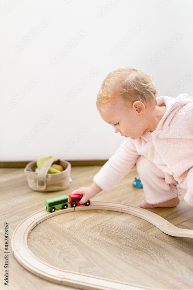 Toddler playing with a wooden toy train