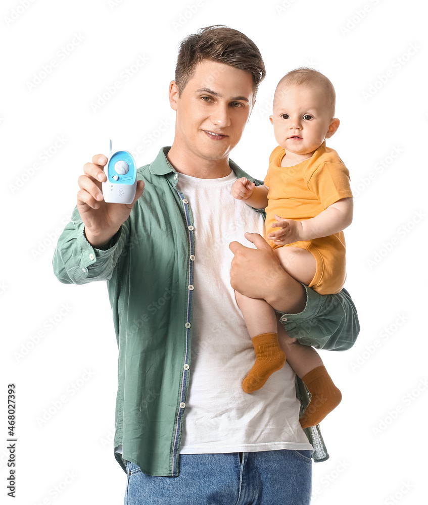 Young father with little child and baby monitor on white background