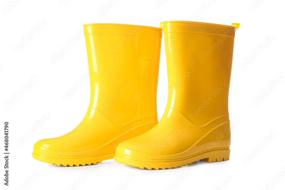 Pair of yellow rubber boots on white background