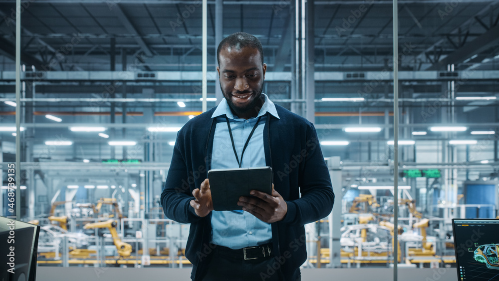 Car Factory Office: Portrait of Successful Black Male Chief Engineer Using Tablet Computer in Automa