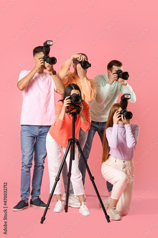 Group of photographers on color background