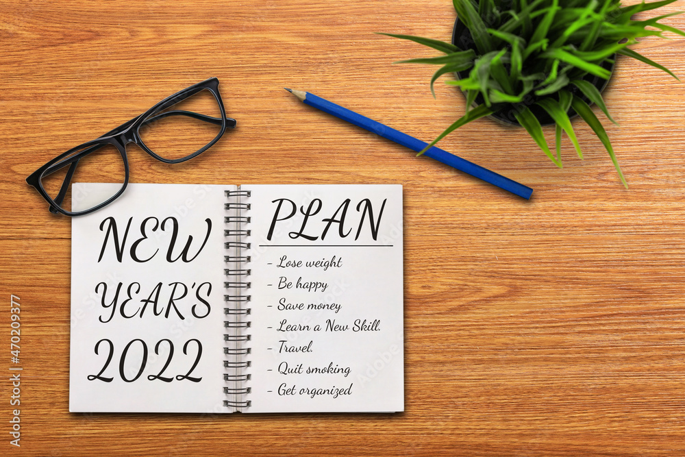 2022 Happy New Year Resolution Goal List and Plans Setting - Business office desk with notebook writ