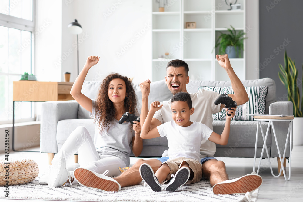 Happy interracial family playing video game at home