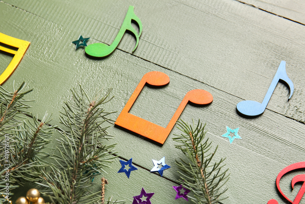 圣诞装饰，杉木树枝和彩色木质背景上的音符标志，特写
