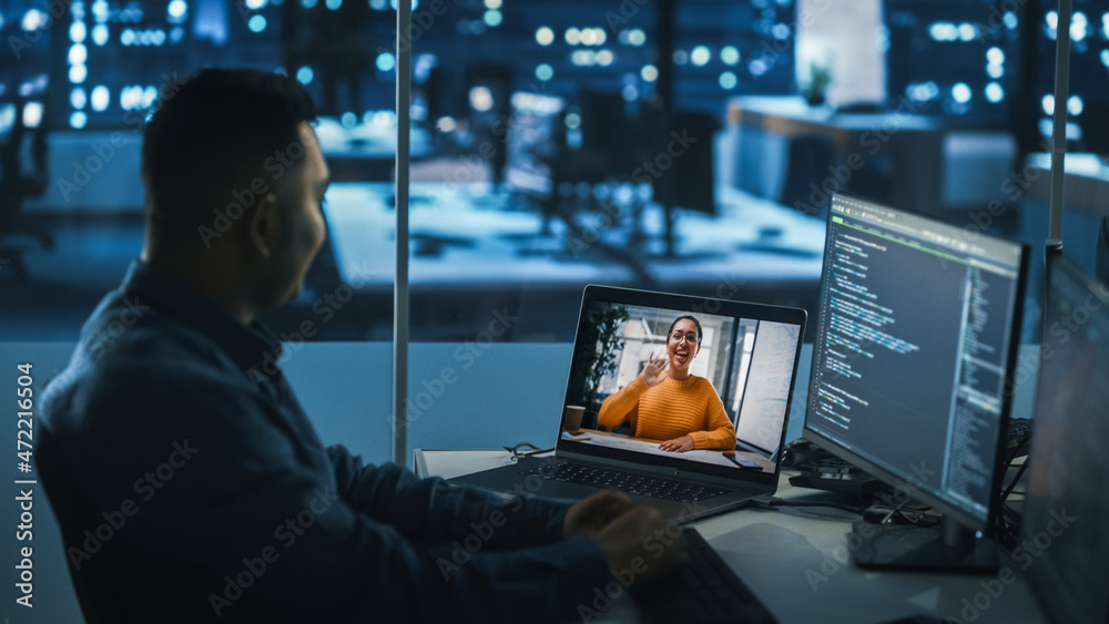 Remote Teamwork In Office at Night: Project Manager Talks with Creative Solutions Specialist Via Vid