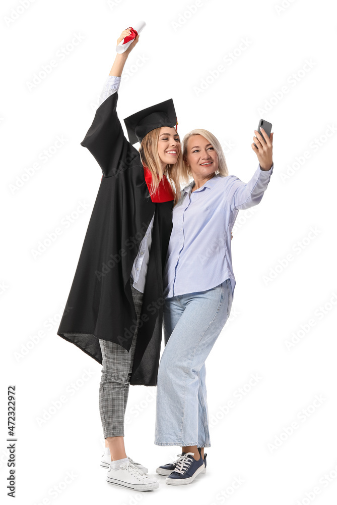 快乐的女毕业学生和她的妈妈在白底自拍