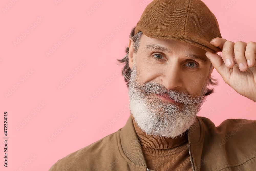 Stylish mature man on color background