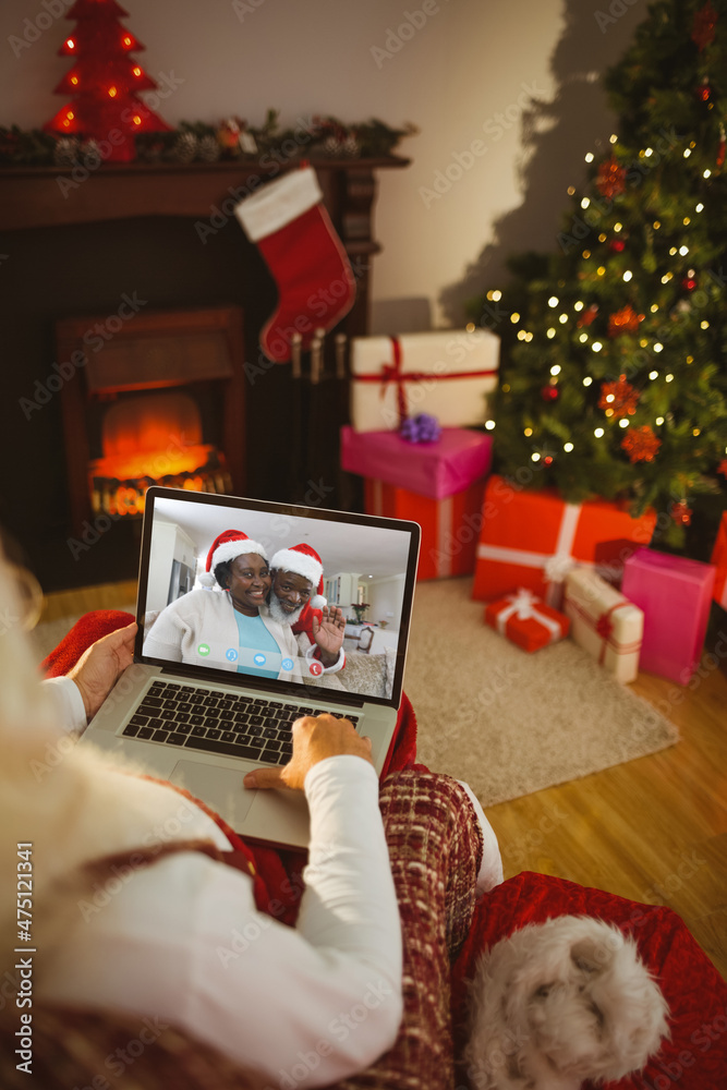 圣诞老人与一对微笑的非洲裔美国老夫妇进行笔记本电脑圣诞视频通话
