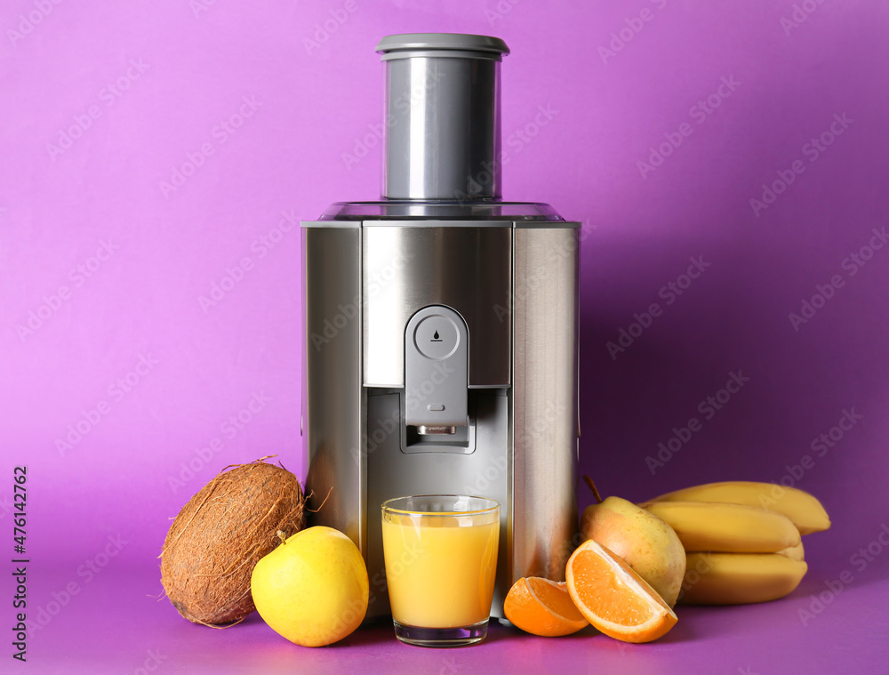 Modern juicer with fresh fruits on purple background
