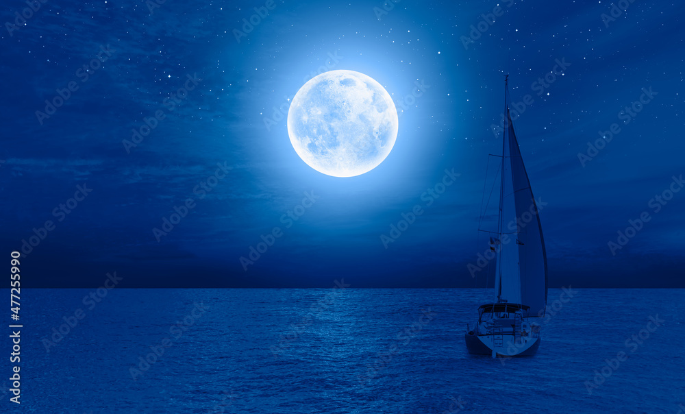 Lone yacht with Super Full Moon Elements of this image furnished by NASA 