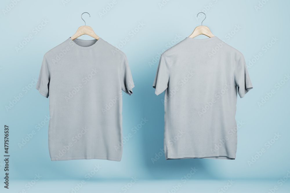 Empty gray t-shirts on blue wall background, Product design and presentation concept. Mock up logo. 